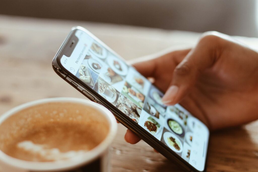 An individual looks at social media on their phone representing the time humans spend doom scrolling on their phones which can cause social anxiety. Therapy for Anxiety in Burbank, CA can help.